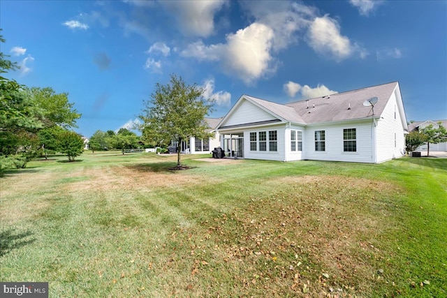 back of house featuring a lawn