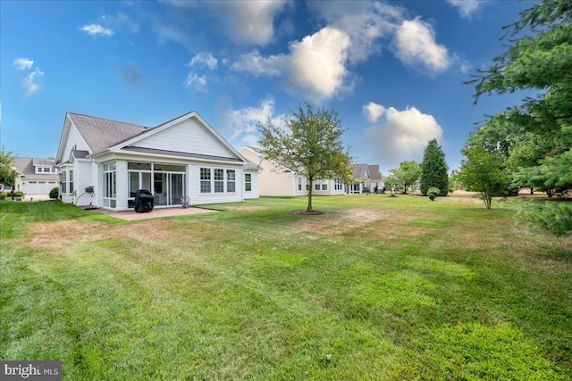 back of property featuring a lawn and a patio area