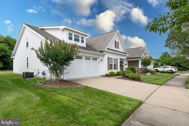 view of front of house featuring central AC unit, a garage, and a front lawn