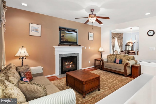 living room with ceiling fan with notable chandelier