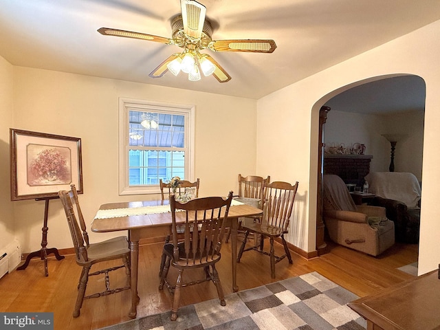 dining area featuring wood-type flooring and ceiling fan