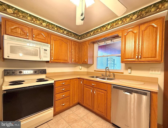 kitchen featuring sink, light tile patterned floors, and white appliances