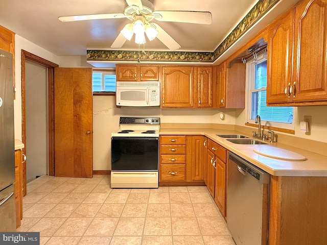 kitchen featuring sink, white appliances, a wealth of natural light, and ceiling fan