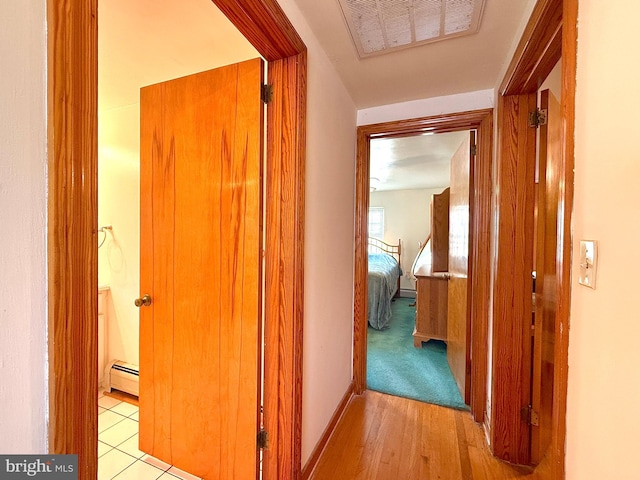 corridor featuring light hardwood / wood-style flooring and a baseboard radiator