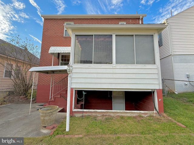 rear view of house featuring a yard