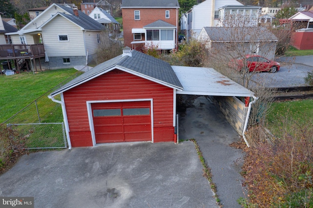 garage with a lawn and a carport