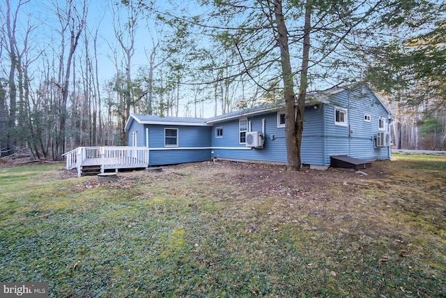 view of front facade with cooling unit, a deck, and a front lawn