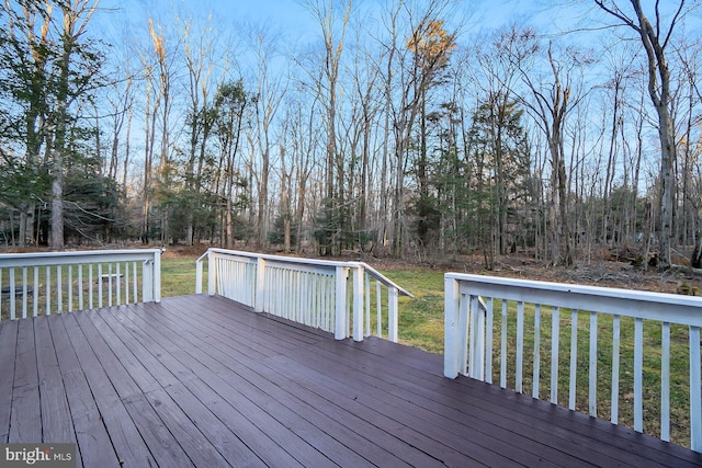 wooden deck with a lawn