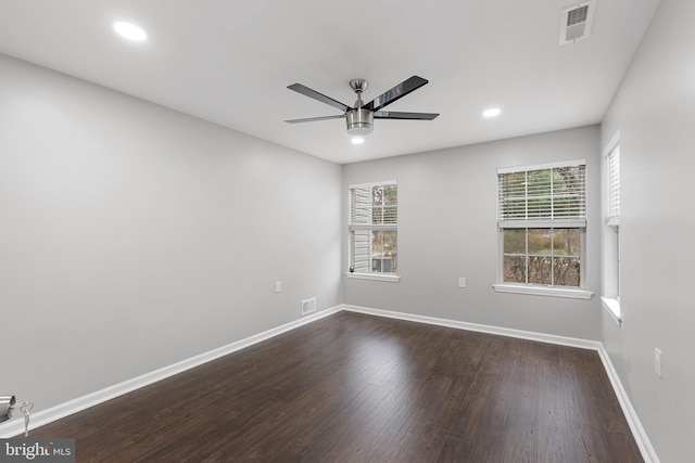 empty room featuring ceiling fan and dark hardwood / wood-style floors