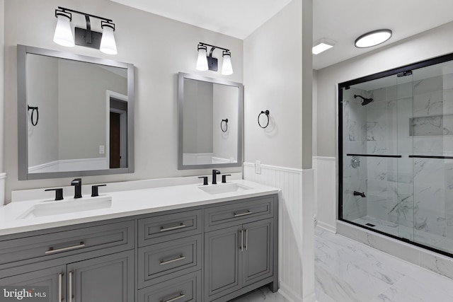 bathroom with vanity and a shower with door