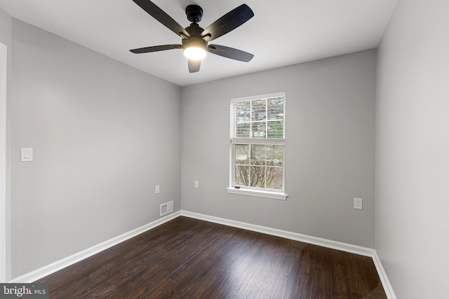 unfurnished room with ceiling fan and dark hardwood / wood-style flooring