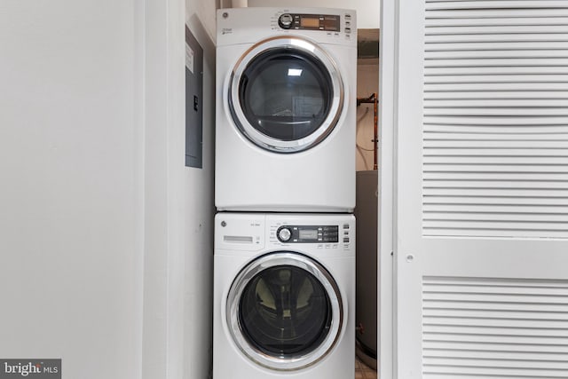 washroom featuring stacked washer and clothes dryer