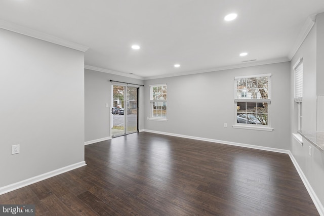 empty room featuring dark hardwood / wood-style floors and crown molding