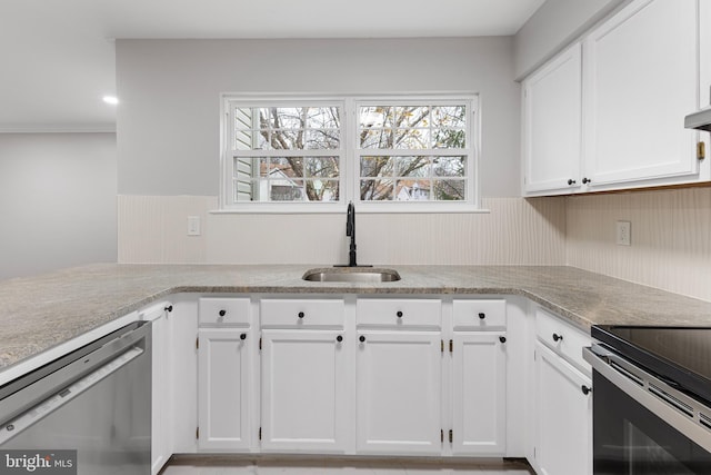 kitchen featuring white cabinets, appliances with stainless steel finishes, and sink