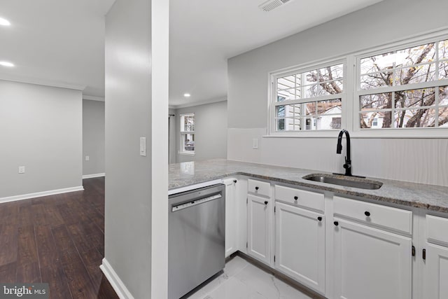 kitchen with stainless steel dishwasher, white cabinetry, sink, and hardwood / wood-style floors