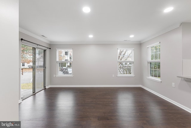 spare room featuring dark hardwood / wood-style flooring and ornamental molding