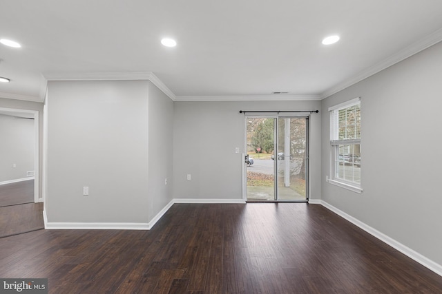 empty room featuring dark hardwood / wood-style flooring and crown molding