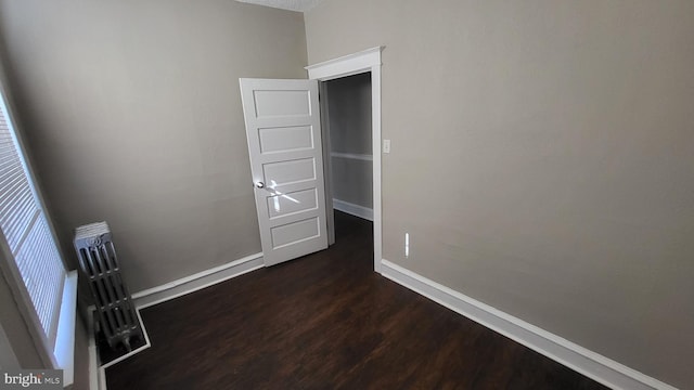 unfurnished room with dark hardwood / wood-style floors