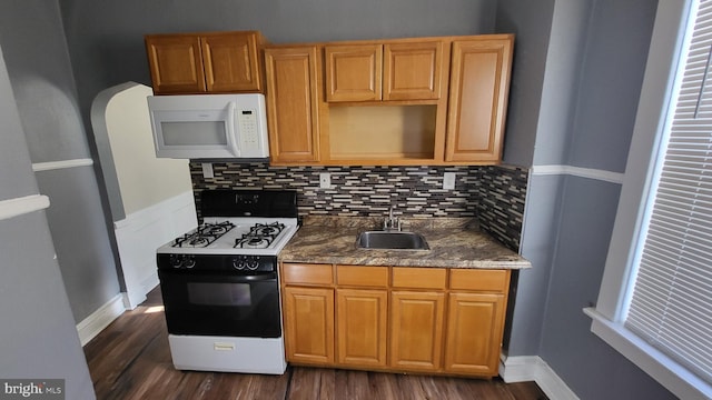 kitchen with white appliances, backsplash, dark hardwood / wood-style floors, and sink