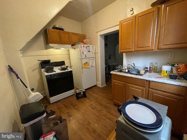 kitchen featuring white appliances and dark wood-type flooring