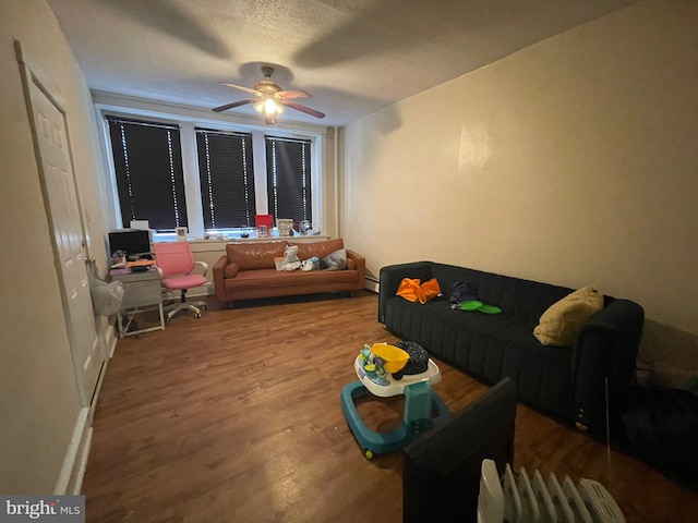 living room with hardwood / wood-style flooring and ceiling fan