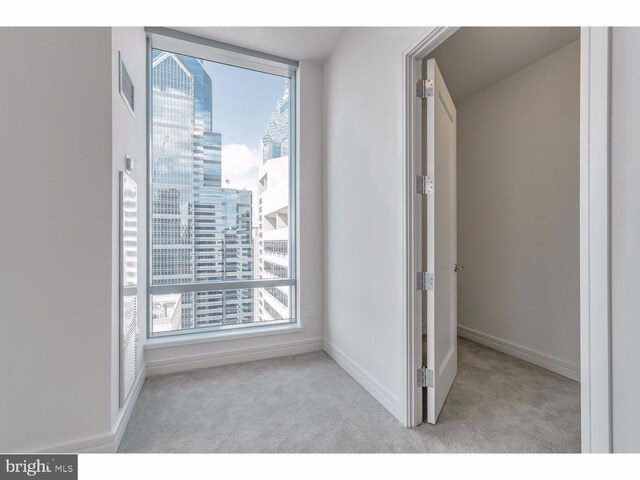 1414 S Penn Sq S Unit 45Gh, Philadelphia, PA 19102 - unfurnished bedroom with carpet, a view of city, and baseboards