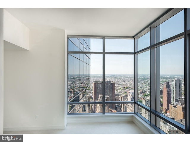 1414 S Penn Sq S Unit 45Gh, Philadelphia, PA 19102 - unfurnished room featuring floor to ceiling windows, a city view, and baseboards