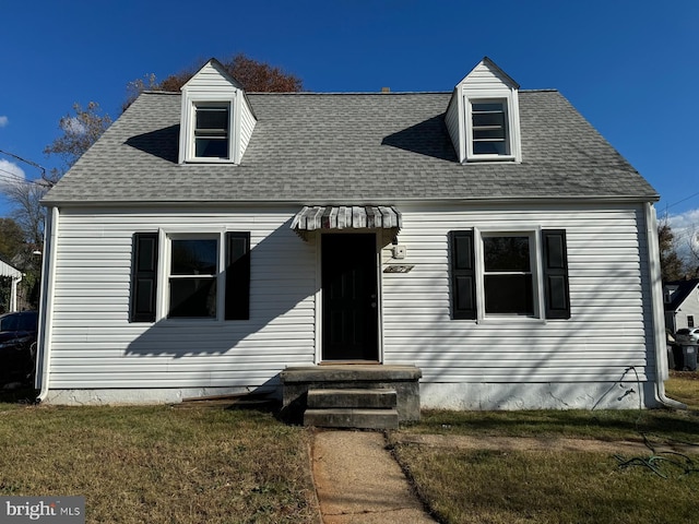 new england style home with a front lawn