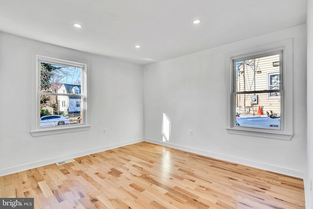 unfurnished room with light hardwood / wood-style flooring