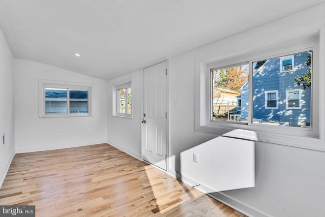 foyer featuring light hardwood / wood-style floors and lofted ceiling