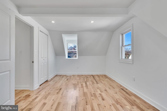 bonus room featuring lofted ceiling and light hardwood / wood-style flooring