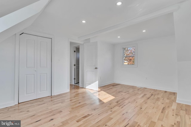 interior space with vaulted ceiling with beams and light hardwood / wood-style floors