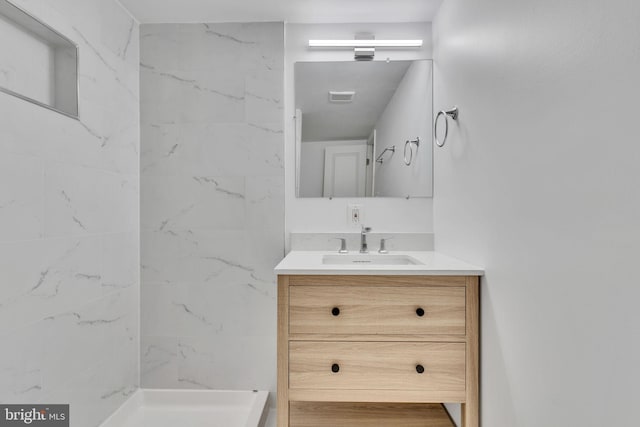 bathroom featuring vanity and a tile shower