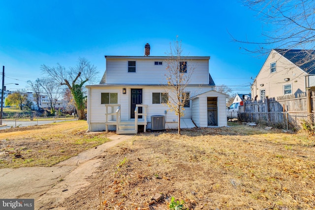 back of house featuring central AC unit