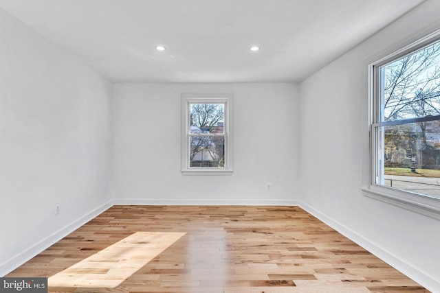 unfurnished room featuring a healthy amount of sunlight and light hardwood / wood-style floors