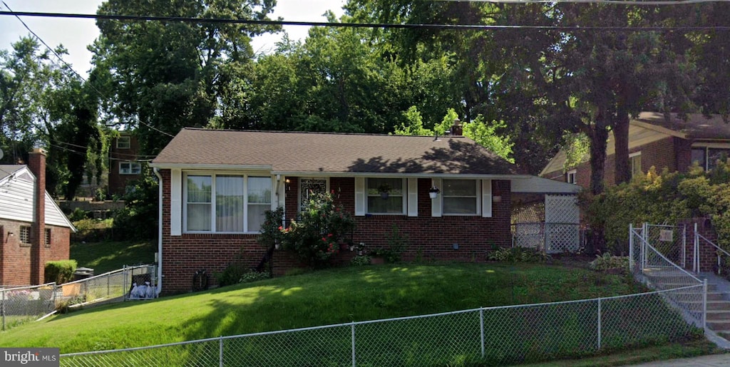 bungalow-style house with a front lawn