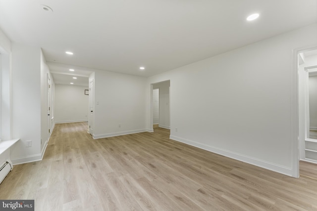 interior space with light hardwood / wood-style flooring and a baseboard heating unit