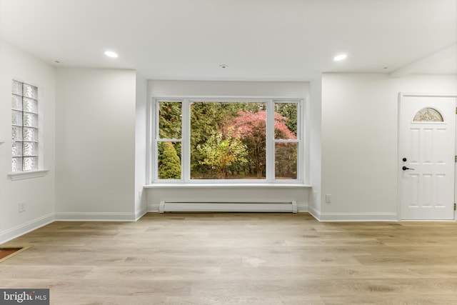 foyer featuring light hardwood / wood-style floors and a baseboard heating unit