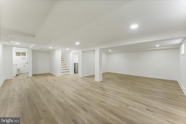 basement with light hardwood / wood-style floors