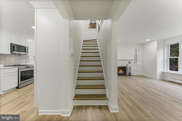 staircase with hardwood / wood-style floors