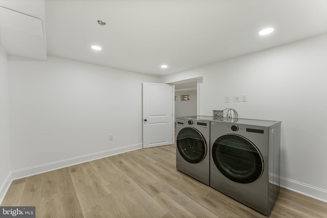 washroom with light hardwood / wood-style floors and independent washer and dryer