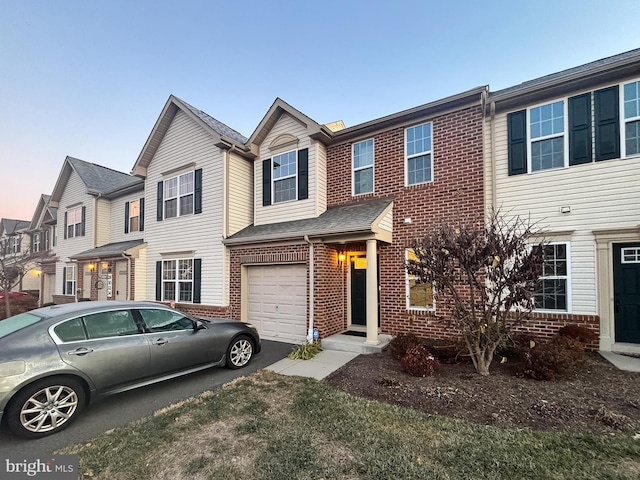 townhome / multi-family property featuring a garage