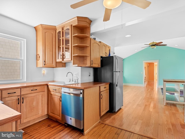 kitchen featuring sink, stainless steel appliances, wood counters, lofted ceiling, and light wood-type flooring