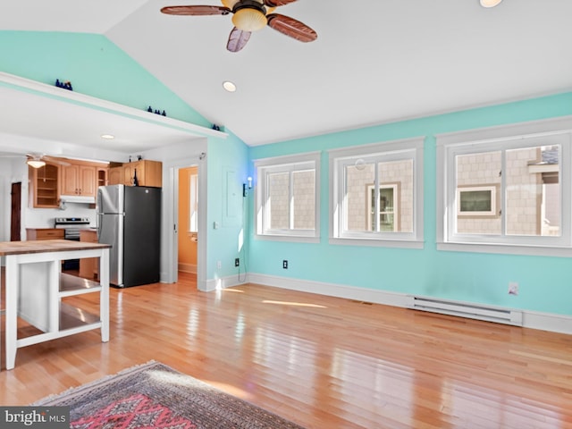 108 Philadelphia St Unit B, Rehoboth Beach, DE 19971 - kitchen with appliances with stainless steel finishes, a baseboard radiator, open shelves, vaulted ceiling, and light wood-type flooring