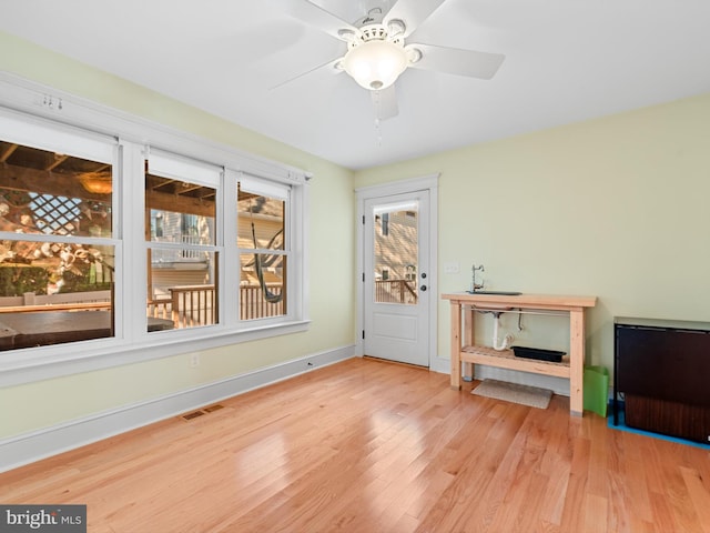 interior space with ceiling fan and light hardwood / wood-style floors