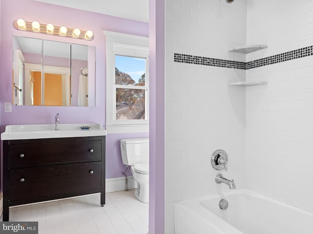 full bathroom featuring vanity, tiled shower / bath combo, and toilet