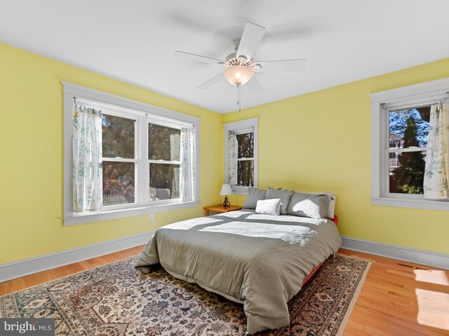 108 Philadelphia St Unit B, Rehoboth Beach, DE 19971 - bedroom featuring multiple windows, wood finished floors, and a ceiling fan