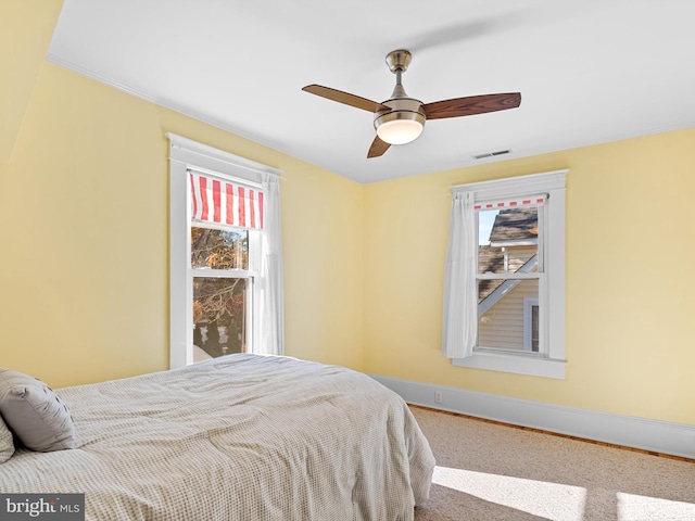 carpeted bedroom with ceiling fan