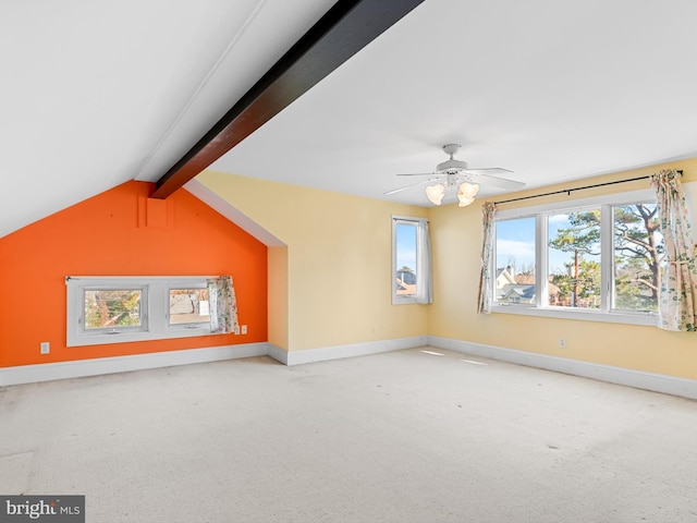 additional living space featuring vaulted ceiling with beams, ceiling fan, and light colored carpet