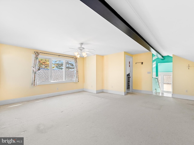 spare room with vaulted ceiling with beams and ceiling fan